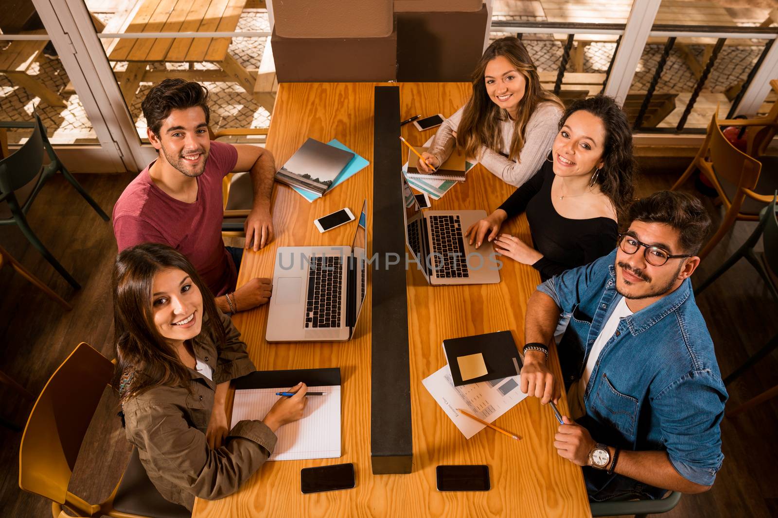 Groups of friends studying together on the bibliotech