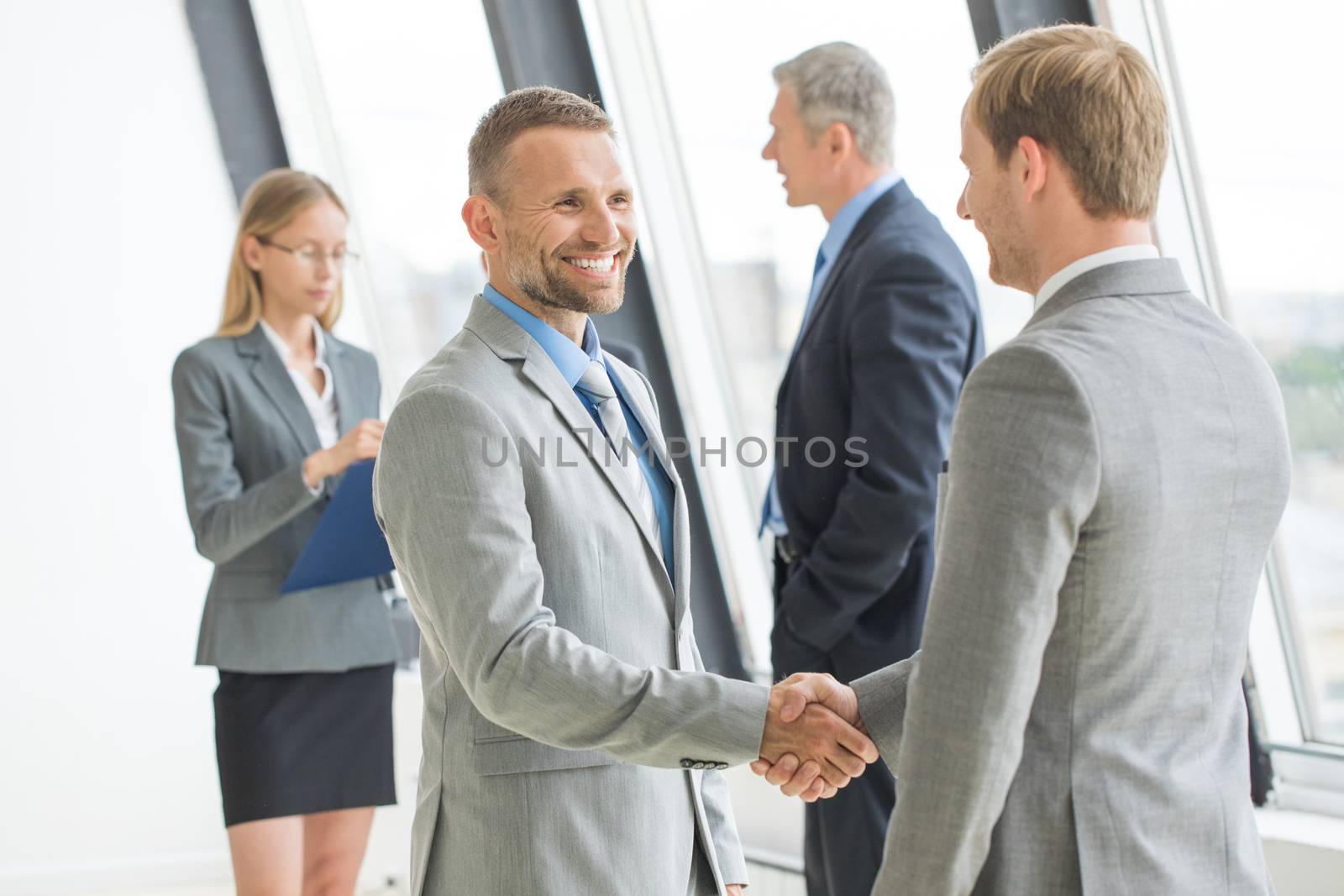 Business people shaking hands by Yellowj
