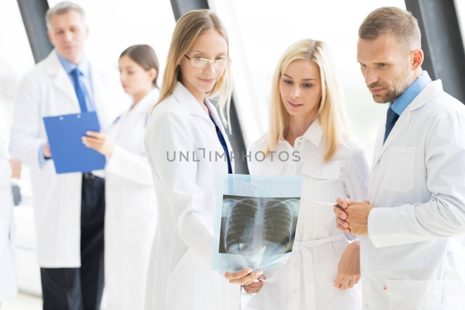 Healthcare, medical and radiology concept - group of doctors looking at x-ray