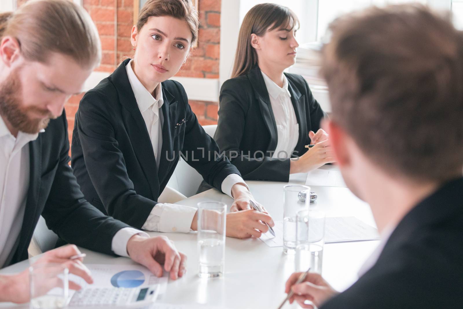 Business people at meeting in office discuss financial charts