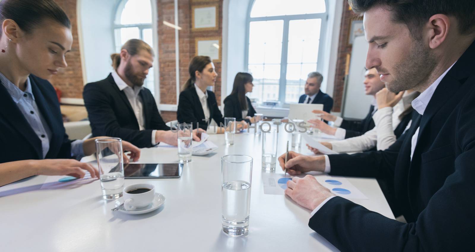 Business people at meeting in office discuss financial charts