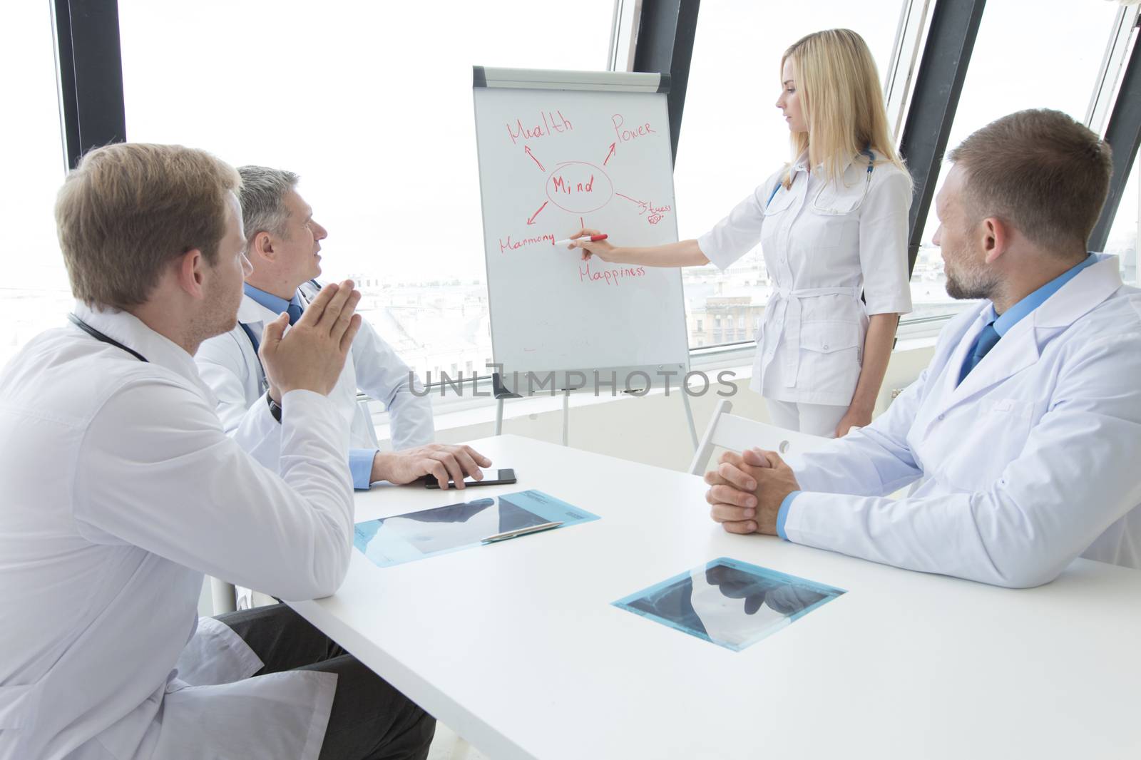 Team of doctors discuss mental health concept at presentation in clinical office