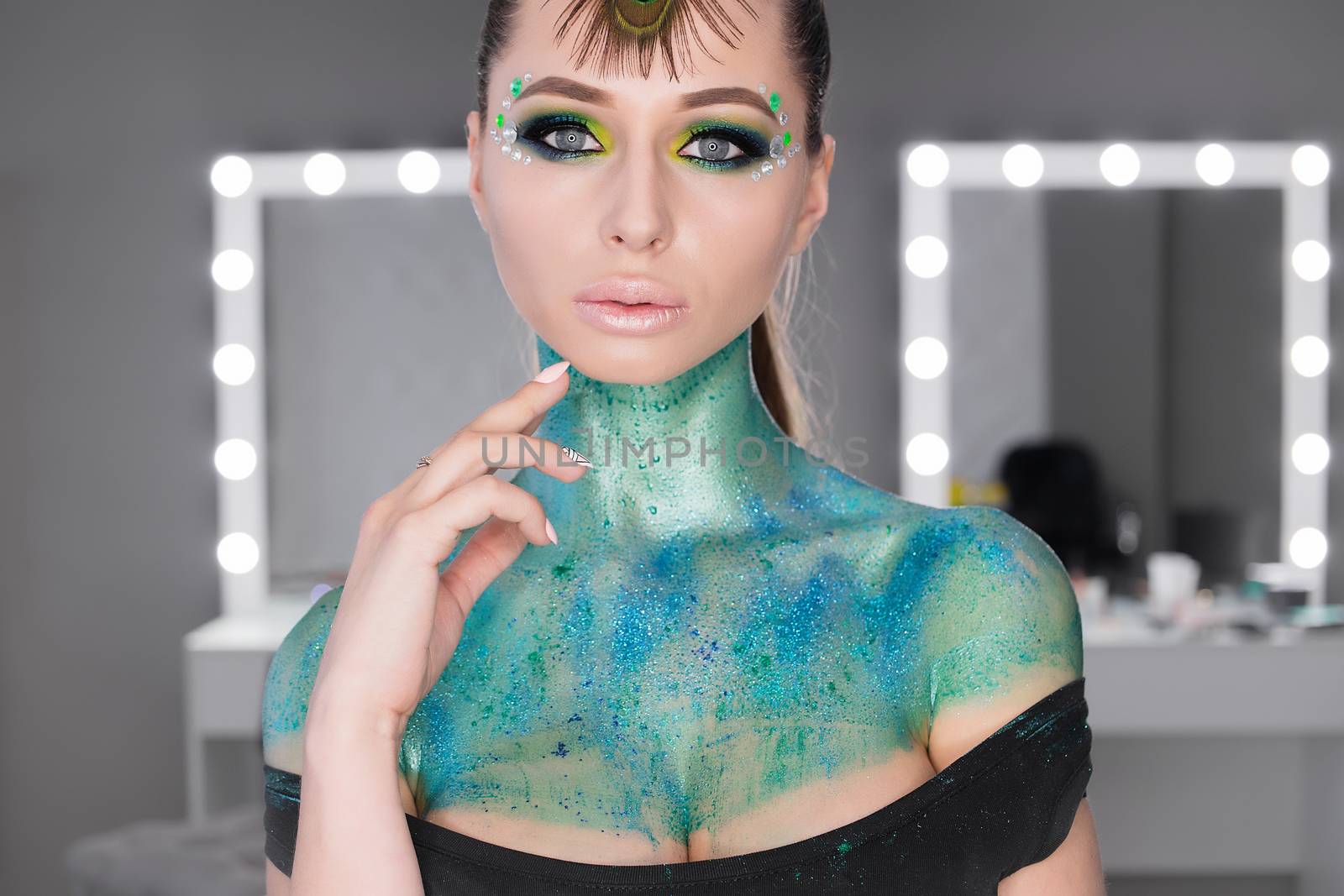 Fashion Art Portrait .Girl with green art makeup.