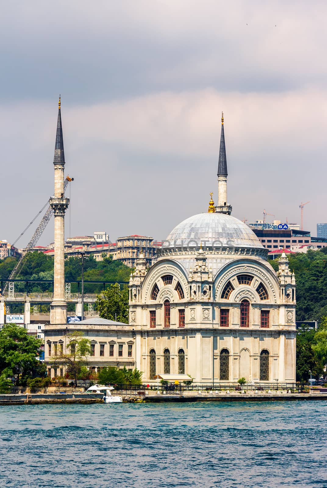 ISTANBUL, TURKEY - AUGUST 18, 2015: Ortakoy Mosque infront of the cityscape, view from the other side of Bosphorus in Istanbul