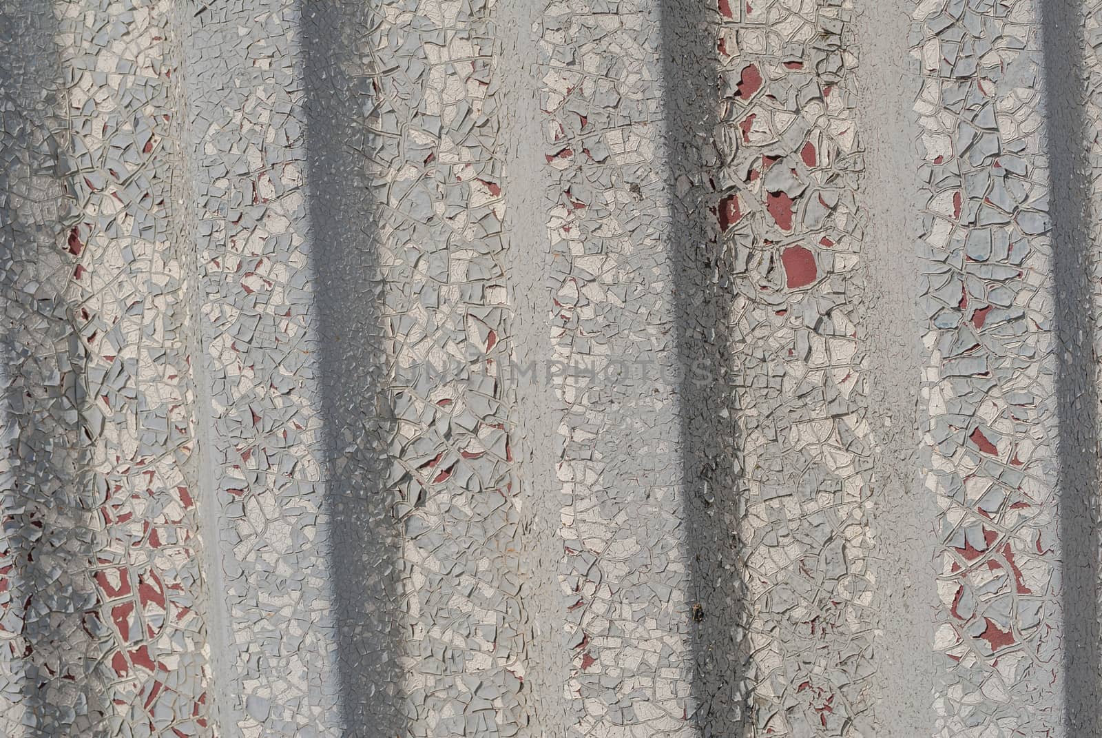 corrugated iron surface is covered with old paint, chipped paint, grey texture, background by uvisni