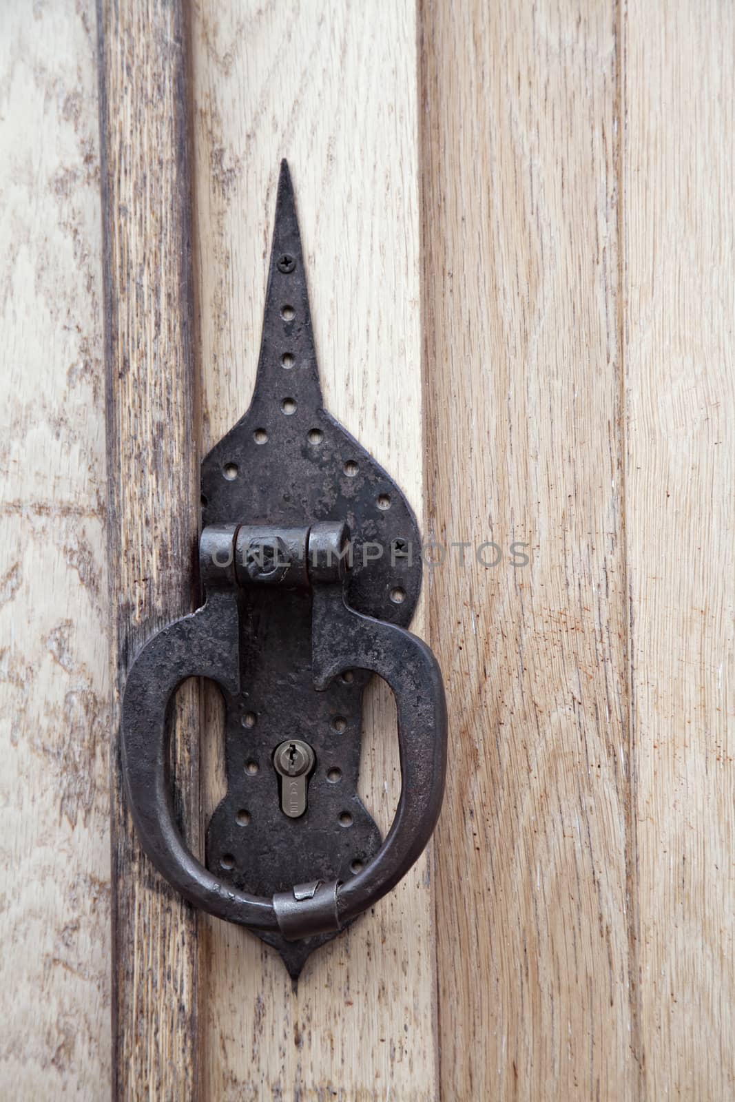 Ring-shaped door knocker on a wooden door