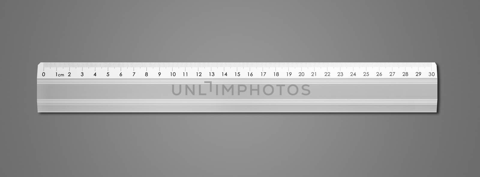 Metal ruler isolated on dark grey background by daboost