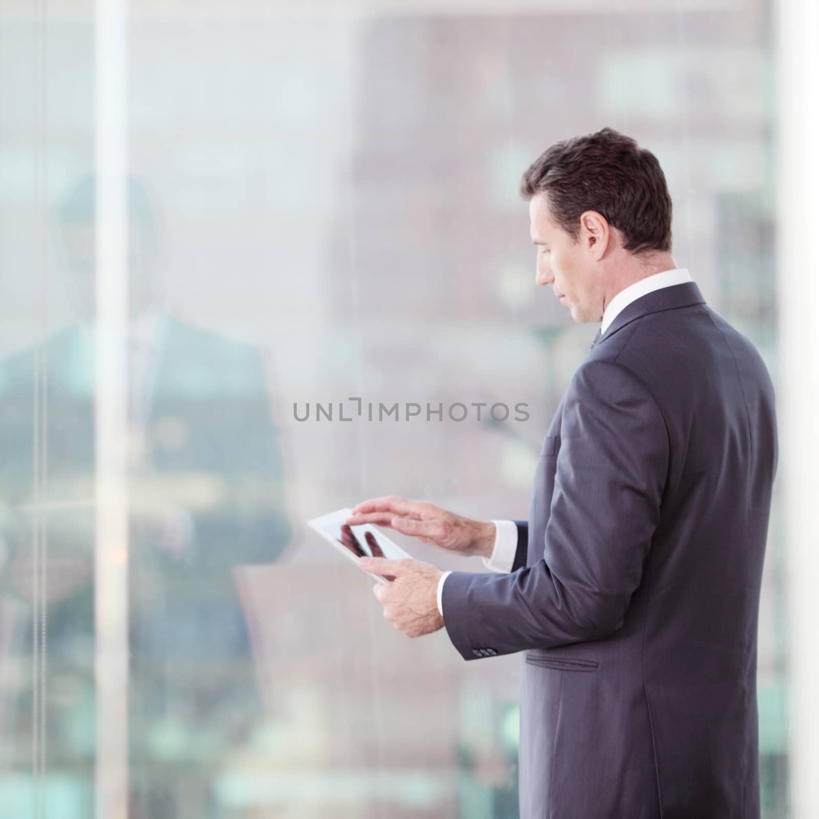 Businessman working with tablet  by ALotOfPeople