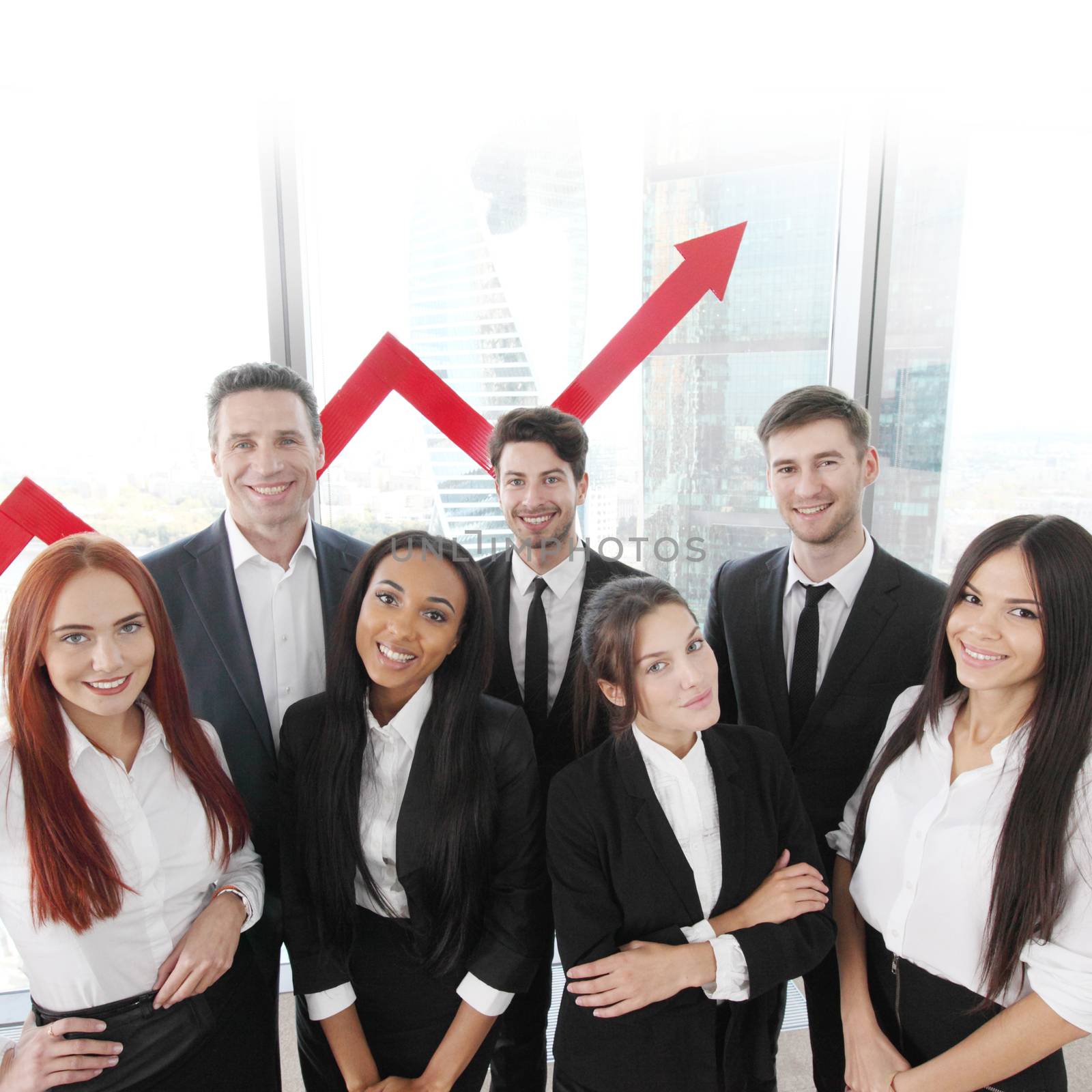 Portrait of business team of men and women in office with arrow graph of income growth