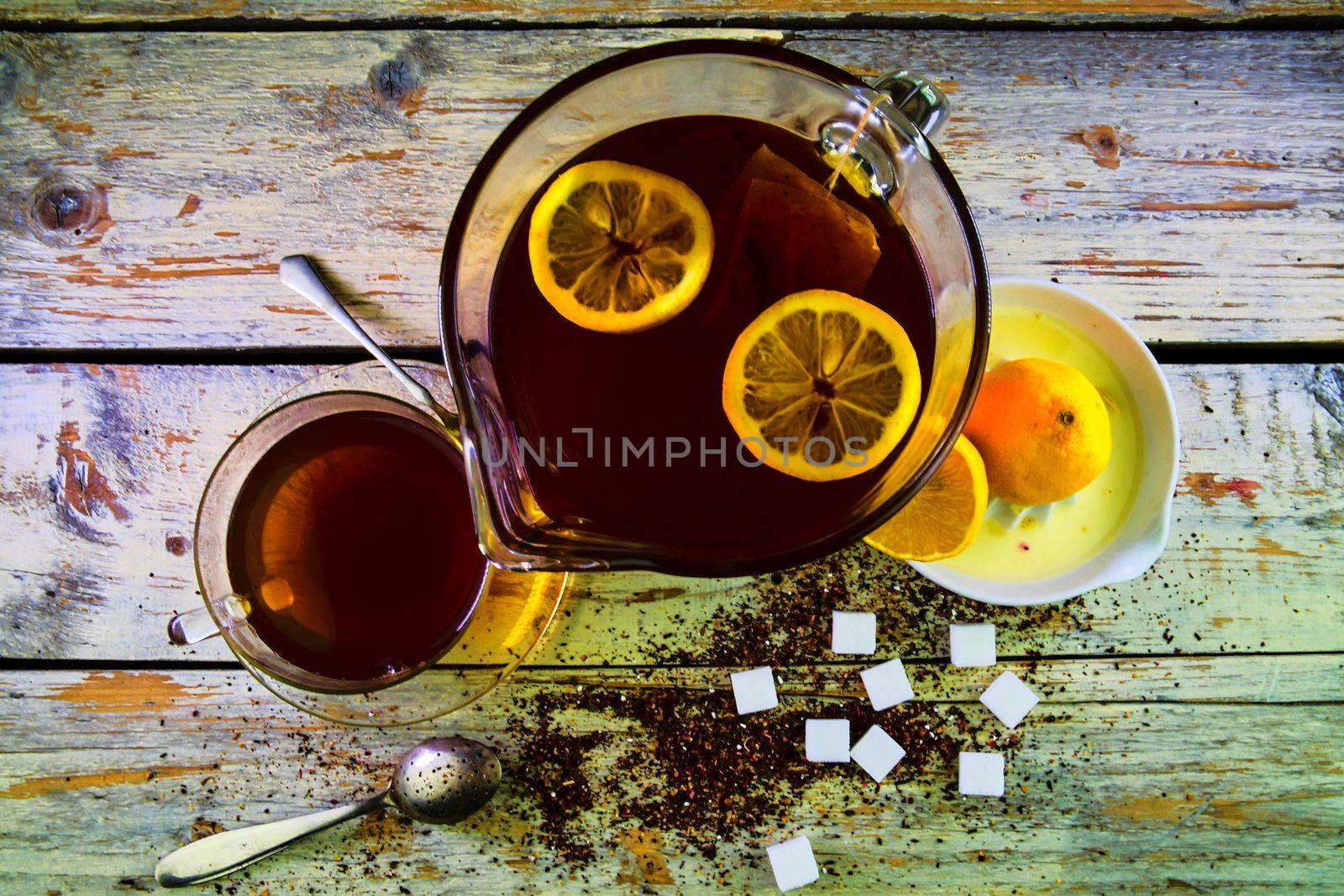 Black tea, manual squeezer with lemons. A jug of black tea and cubes of sugar. Top view, flat design by roman_nerud