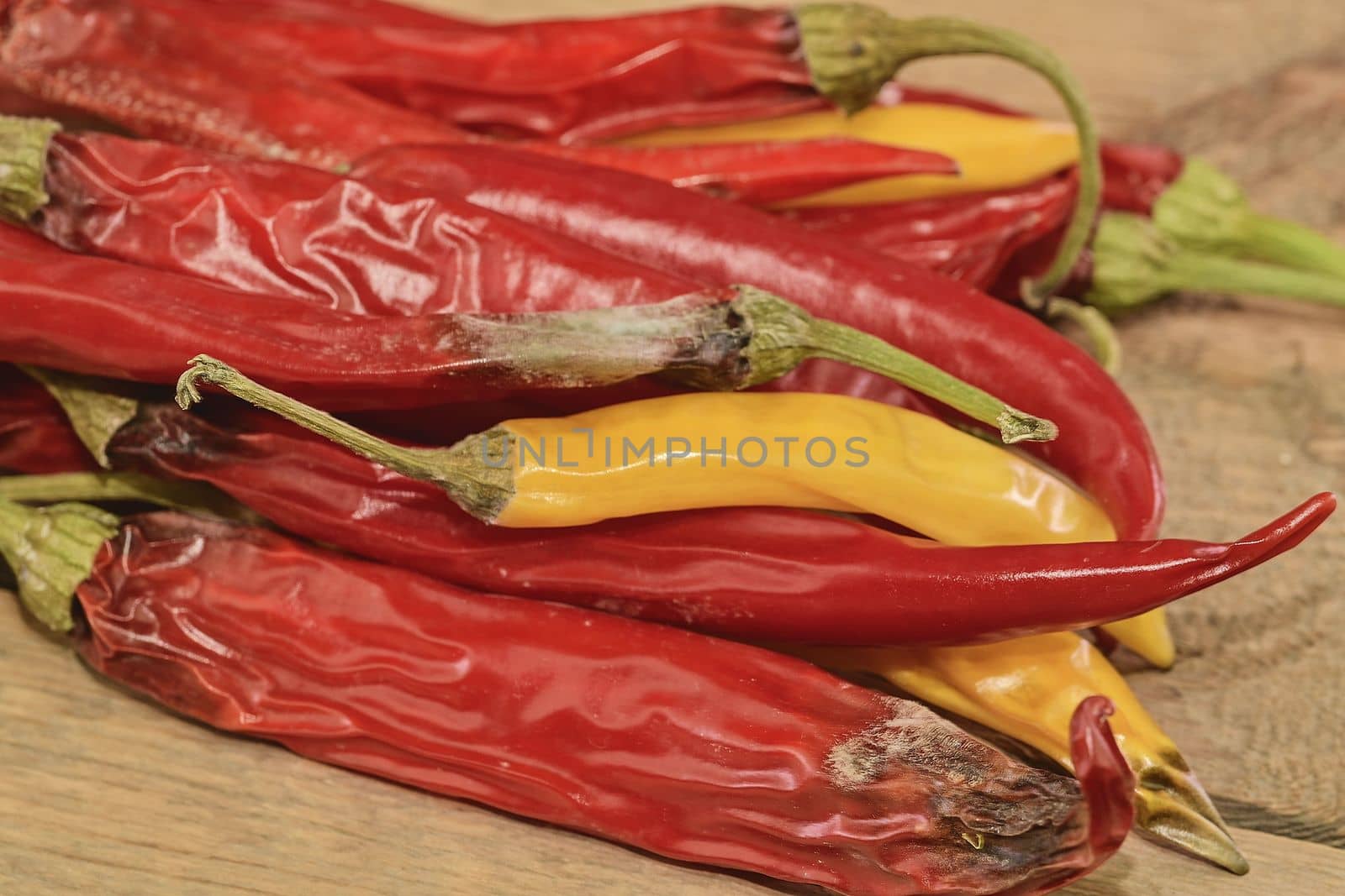 Shrinking and mould chili peppers on wooden background. Rotten chili peppers. Flat design.