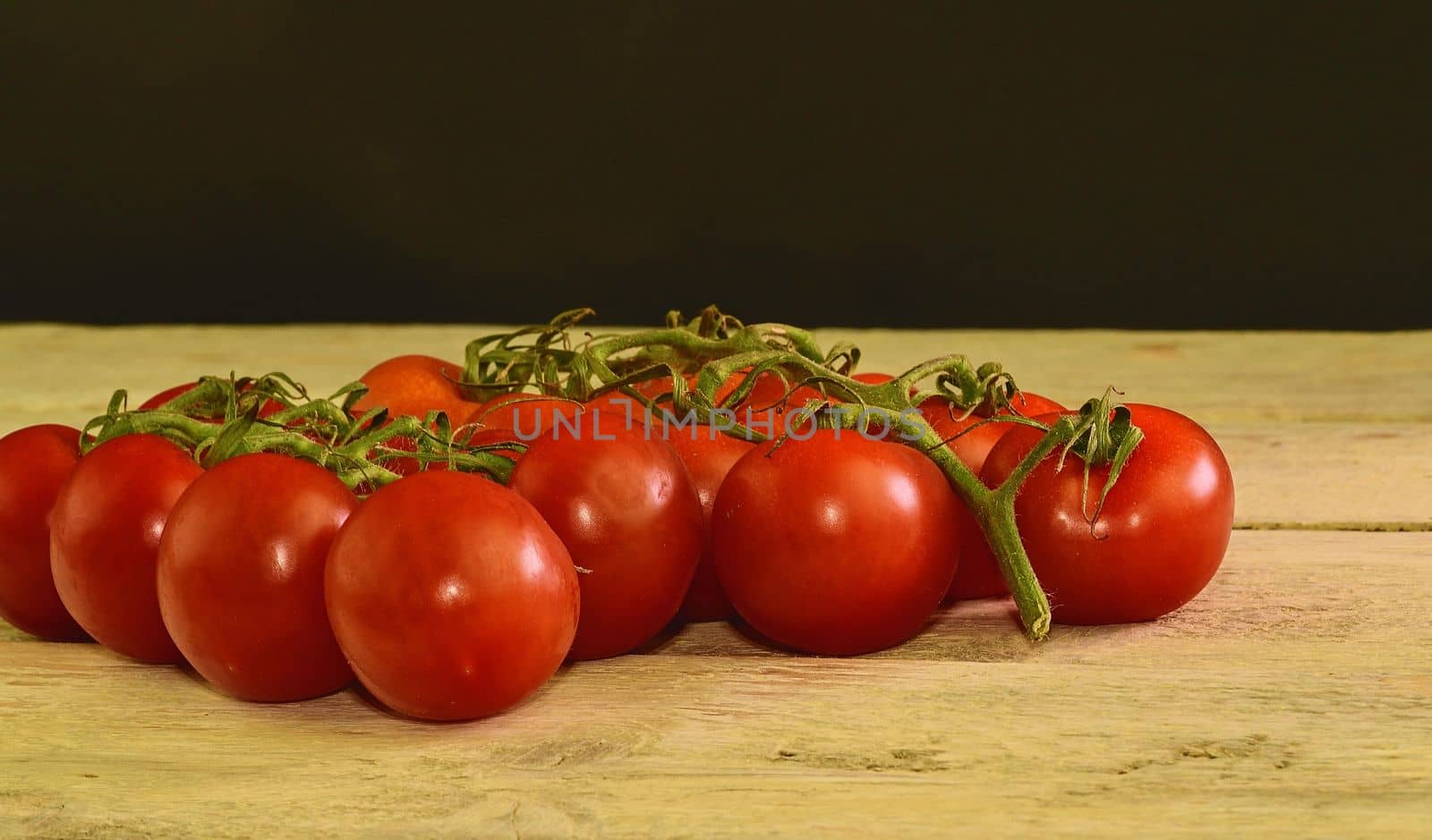 Fresh cherry tomatoes on rustic wooden background. White and black background. Copy space for text by roman_nerud