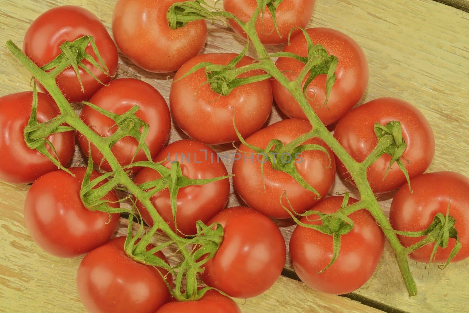 Fresh cherry tomatoes on rustic wooden white background. White background. Close-up.