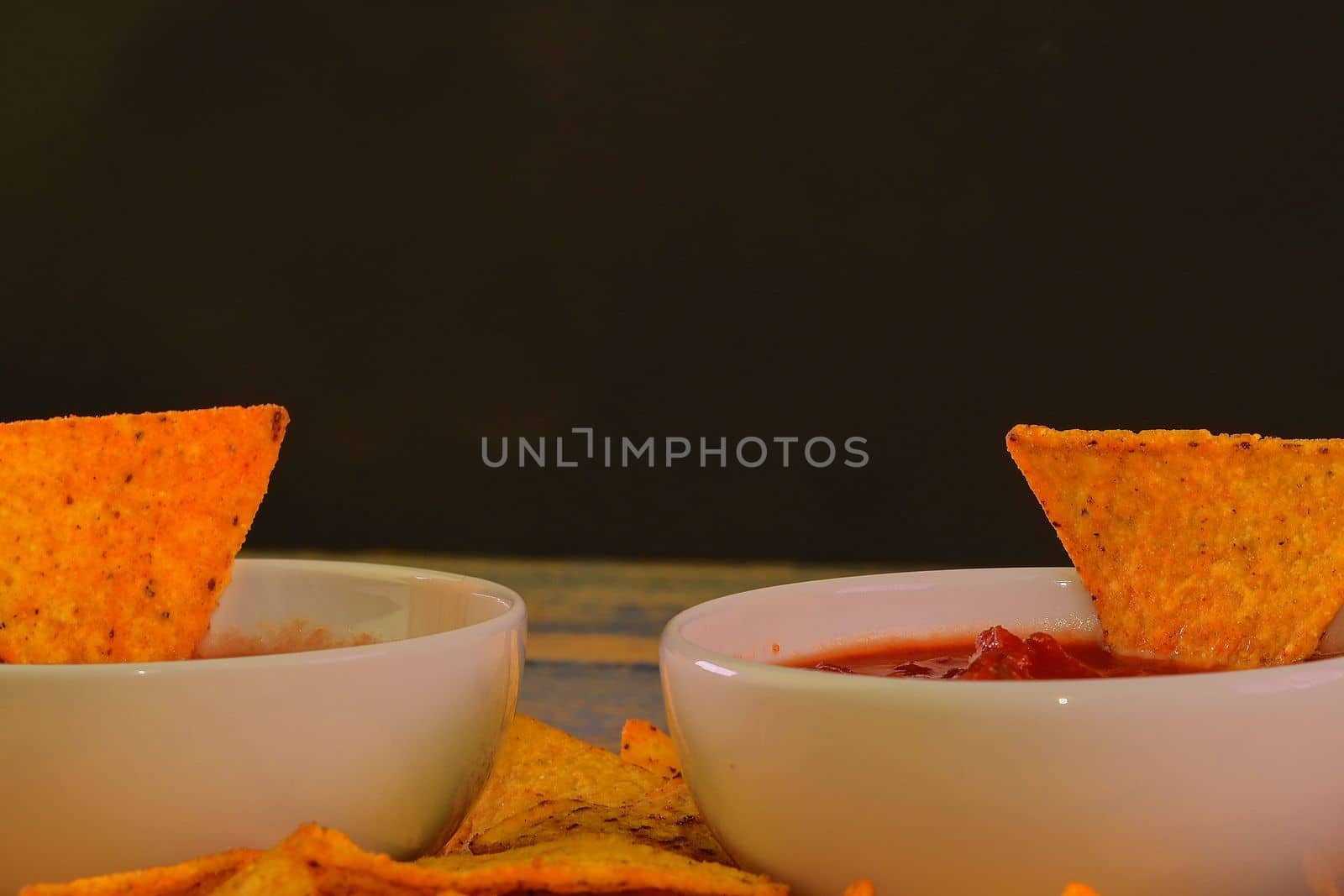 Chili corn-chips with salsa dip on wooden background by roman_nerud
