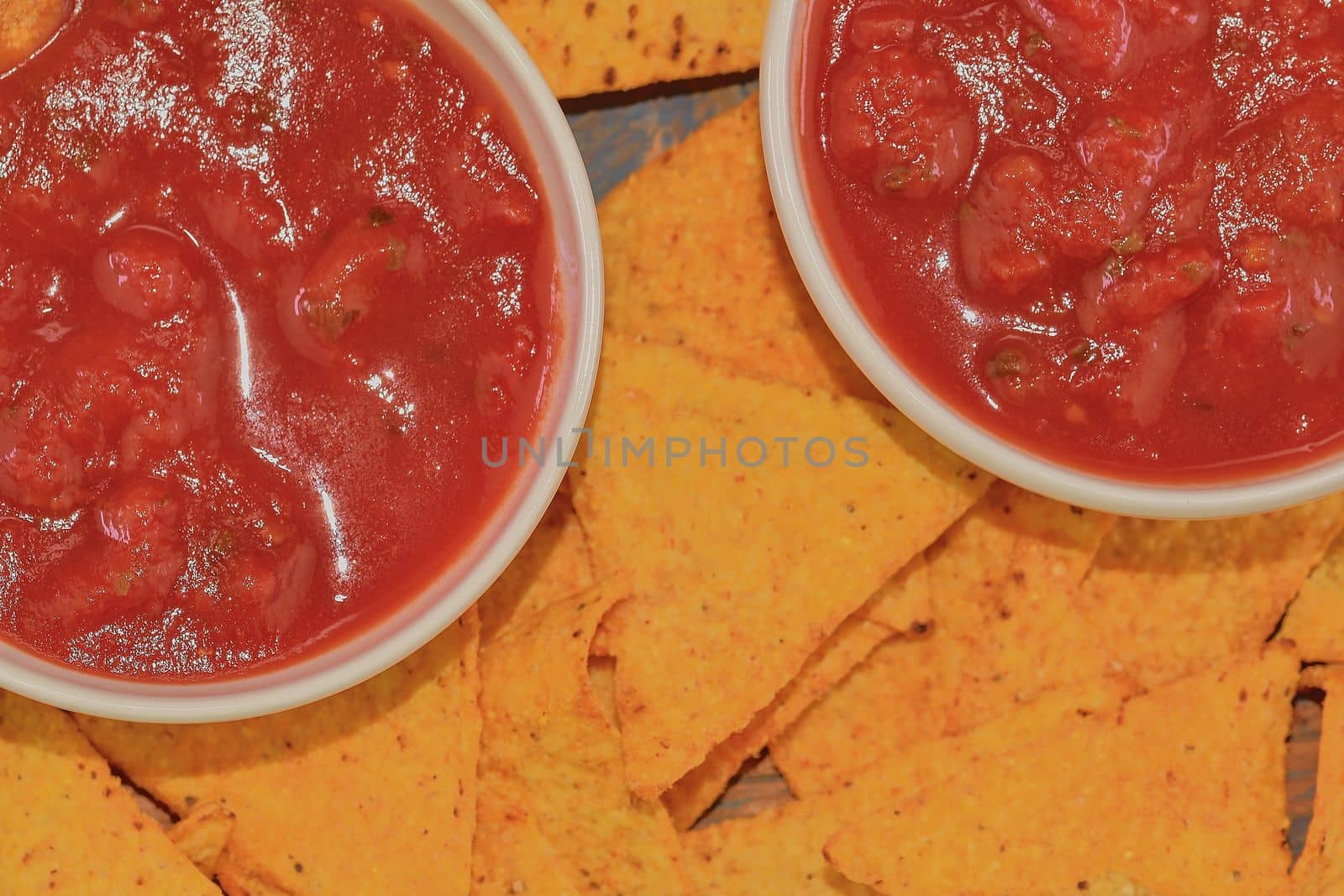 Chili corn-chips with salsa dip on wooden background by roman_nerud