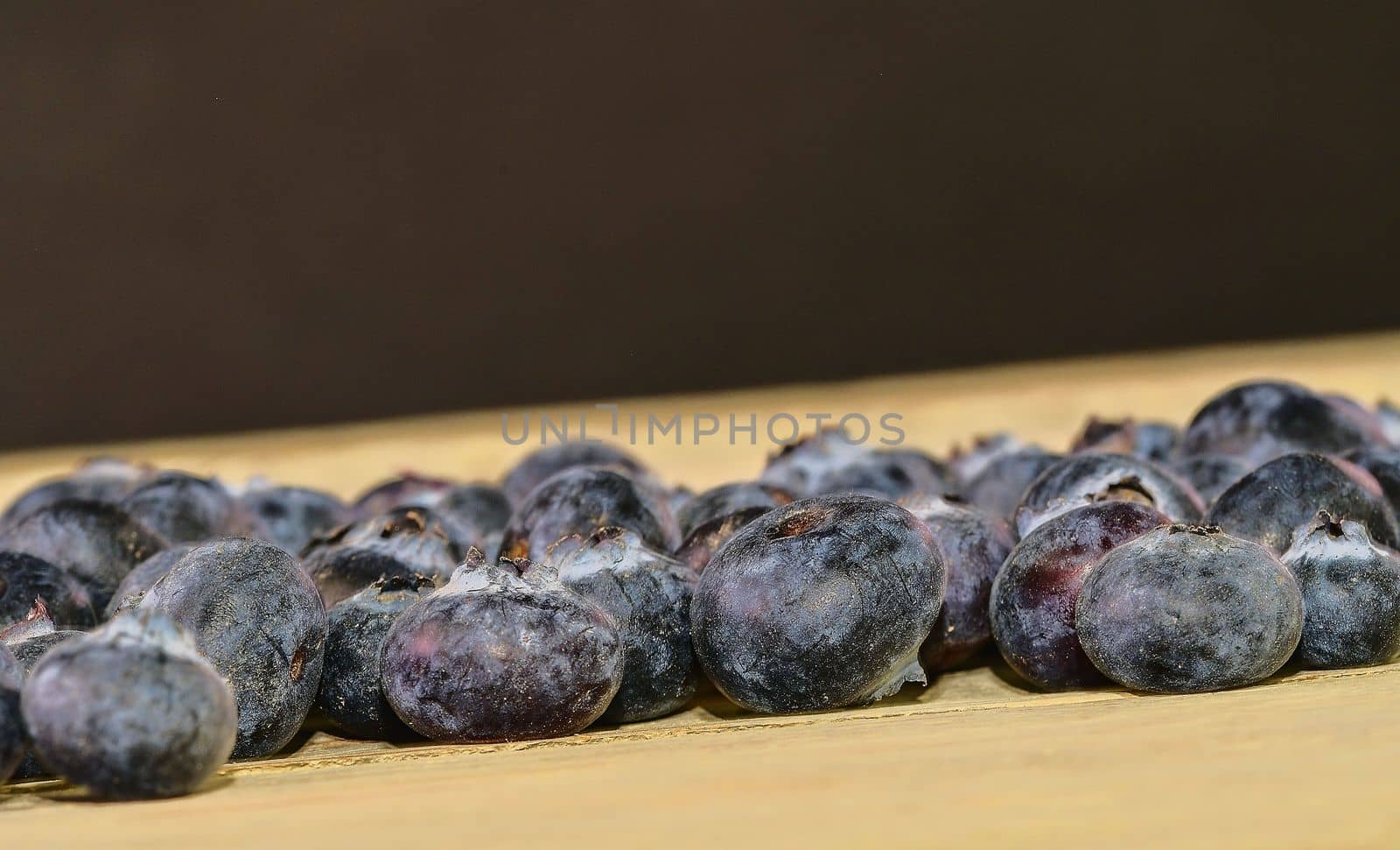 Blueberries  on white wooden background. Bilberries, blueberries, huckleberries, whortleberries. Black and white background. Black copy space
