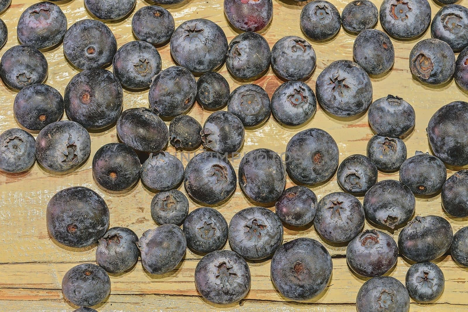 Blueberries  on white wooden background. Bilberries, blueberries, huckleberries, whortleberries Flat design 