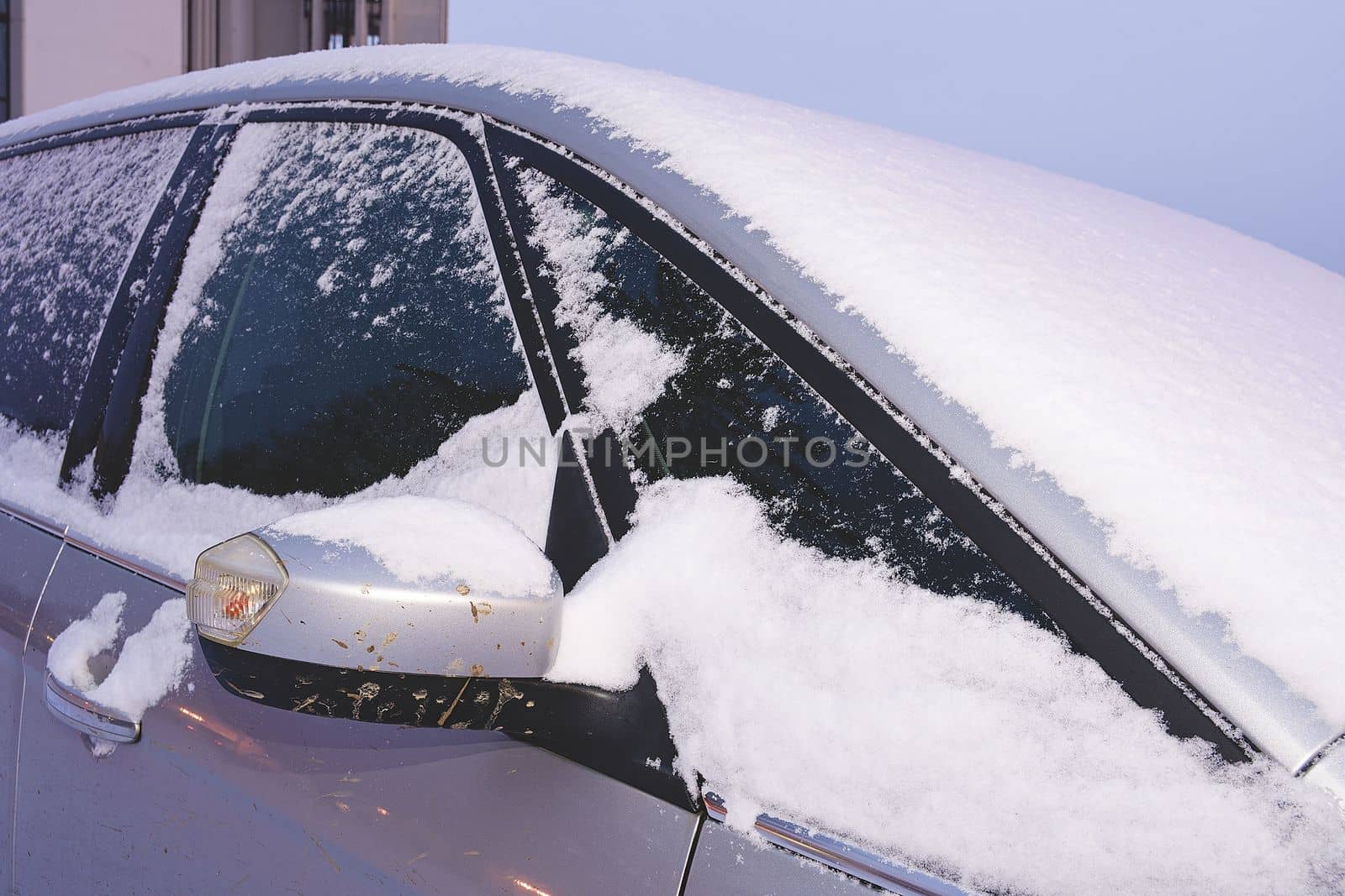 Closeup of a car covered with snow