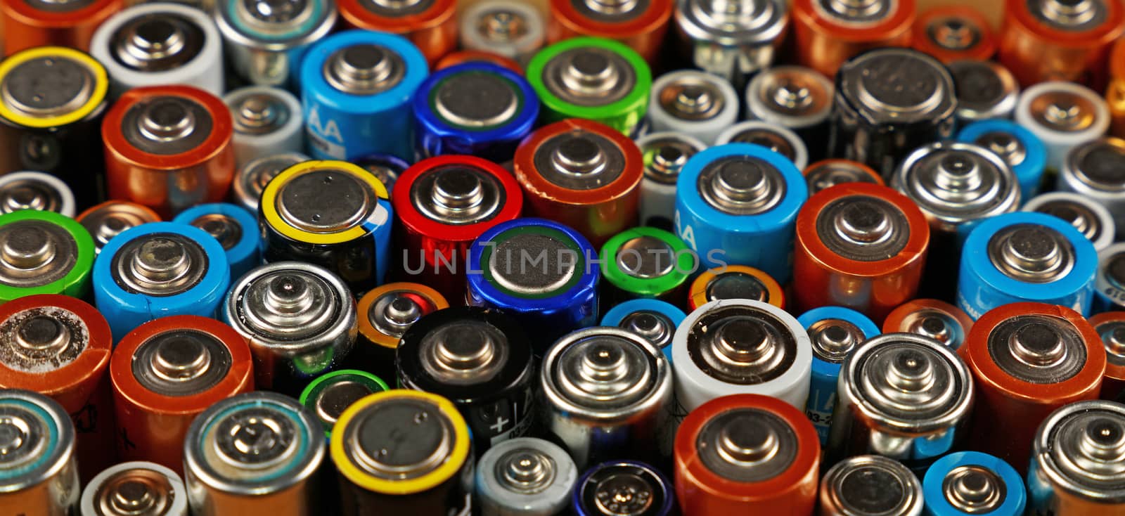 Close up background of various alkaline batteries by BreakingTheWalls