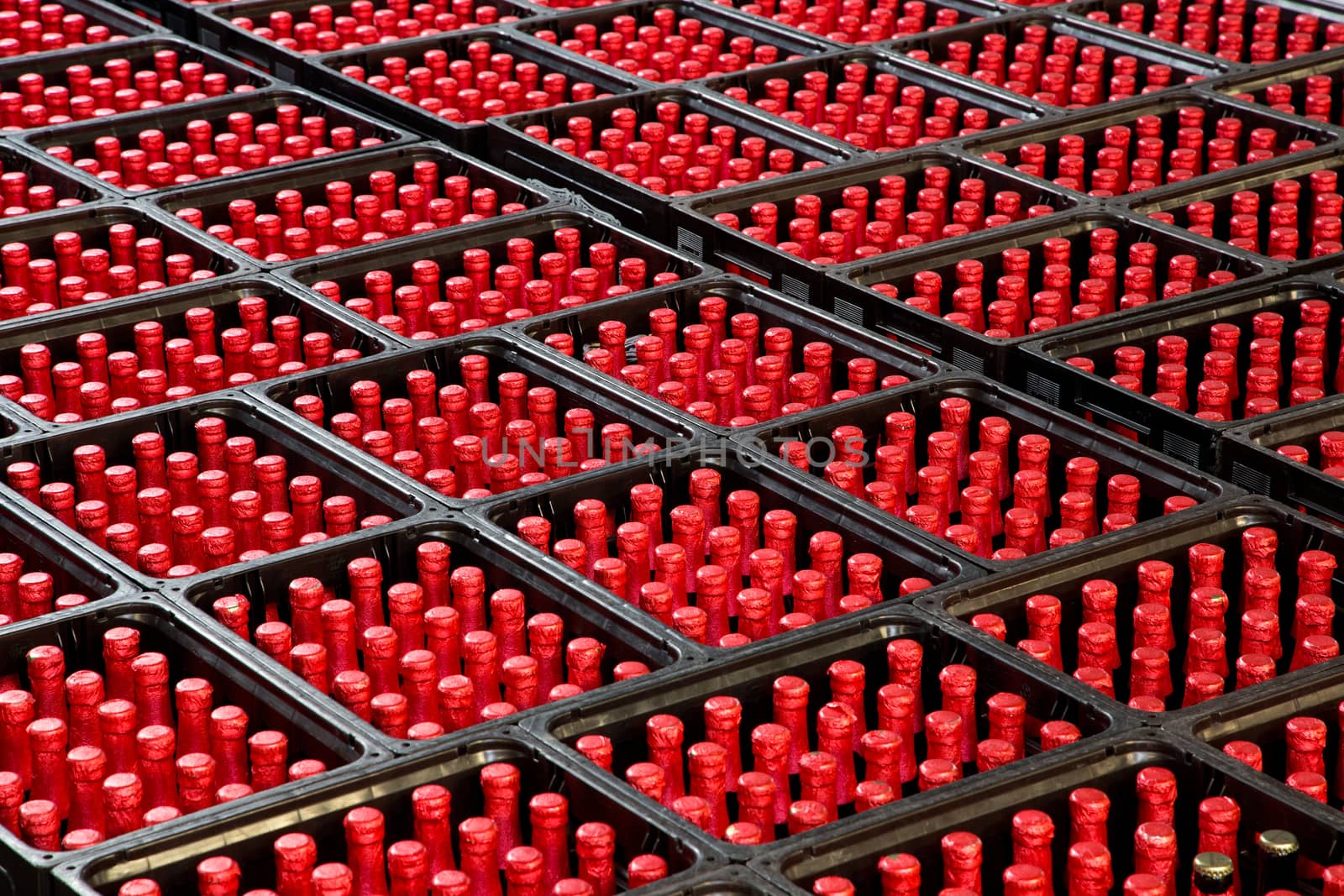 A group of red bottles in beer crates