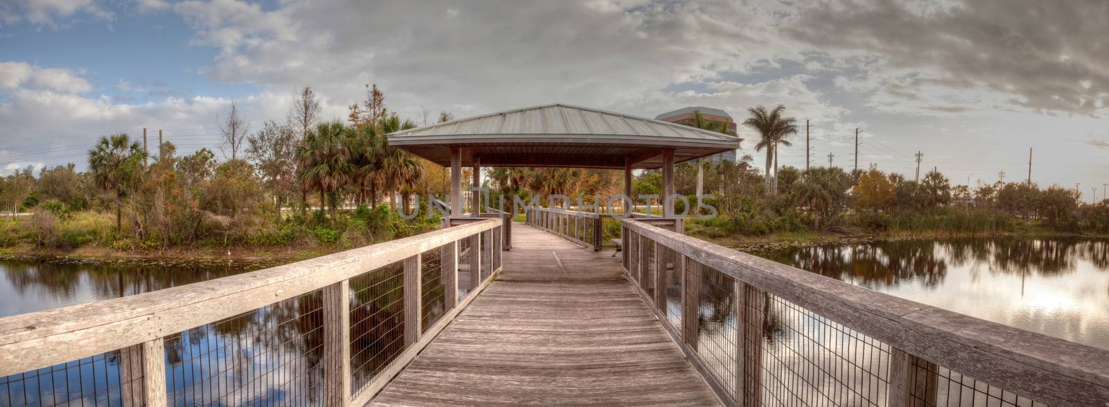 Sunset over Gazebo on a wooden secluded, tranquil boardwalk along a marsh pond in Freedom Park in Naples, Florida