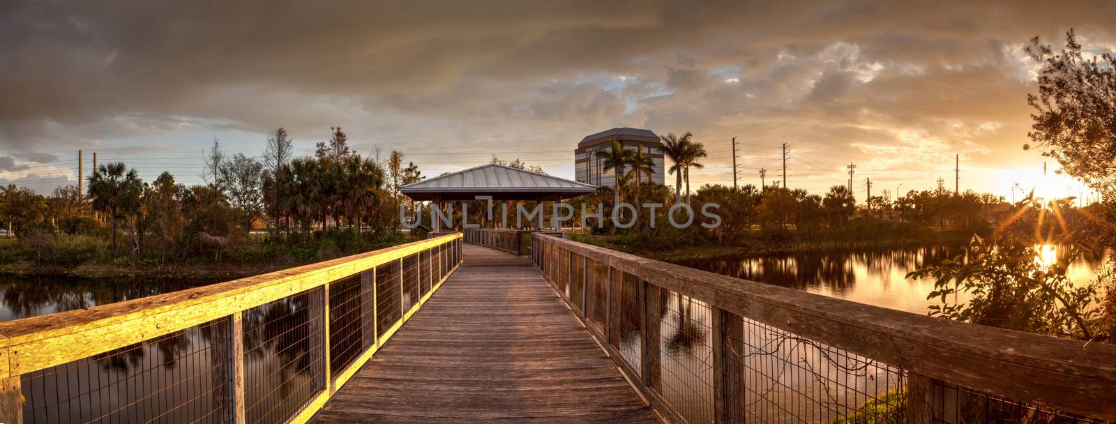 Sunset over Gazebo on a wooden secluded, tranquil boardwalk along a marsh pond in Freedom Park in Naples, Florida