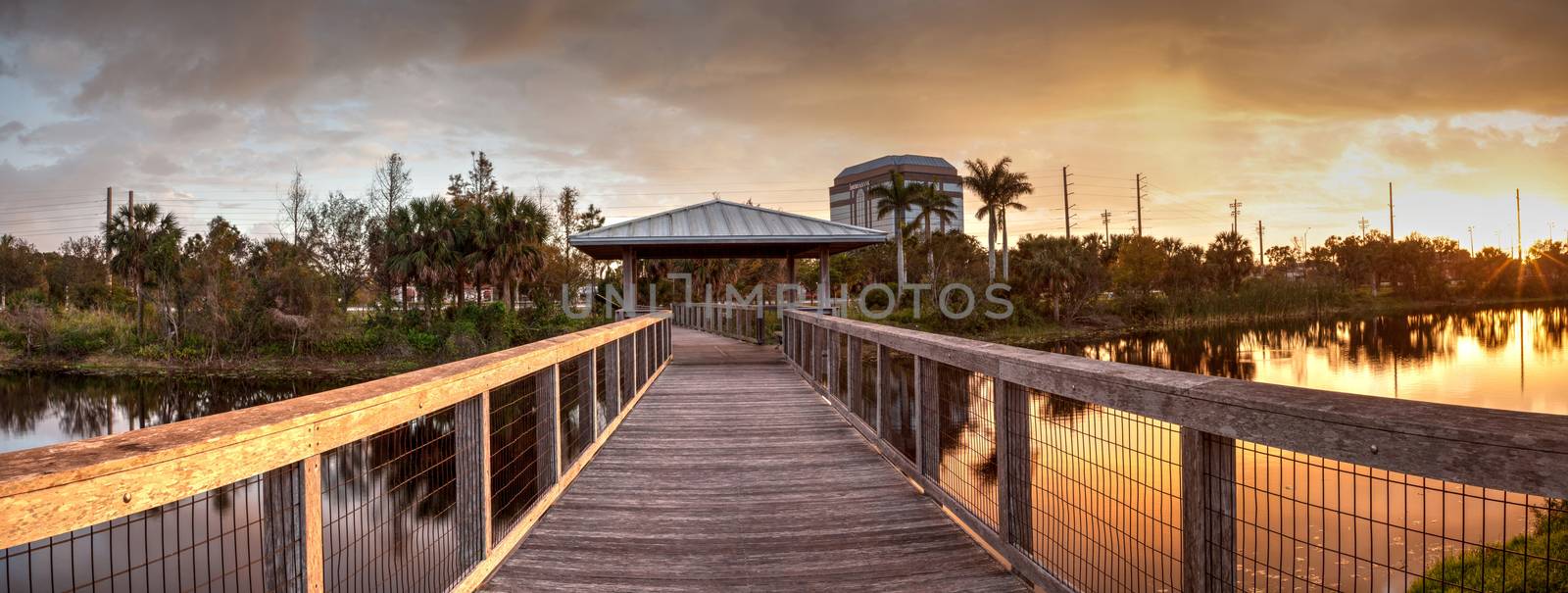 Sunset over Gazebo on a wooden secluded, tranquil boardwalk by steffstarr