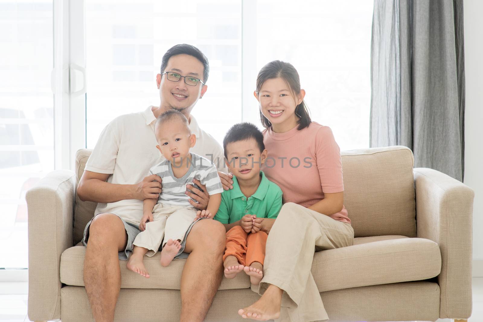 Portrait of happy Asian family at home, parents and children indoor lifestyle.