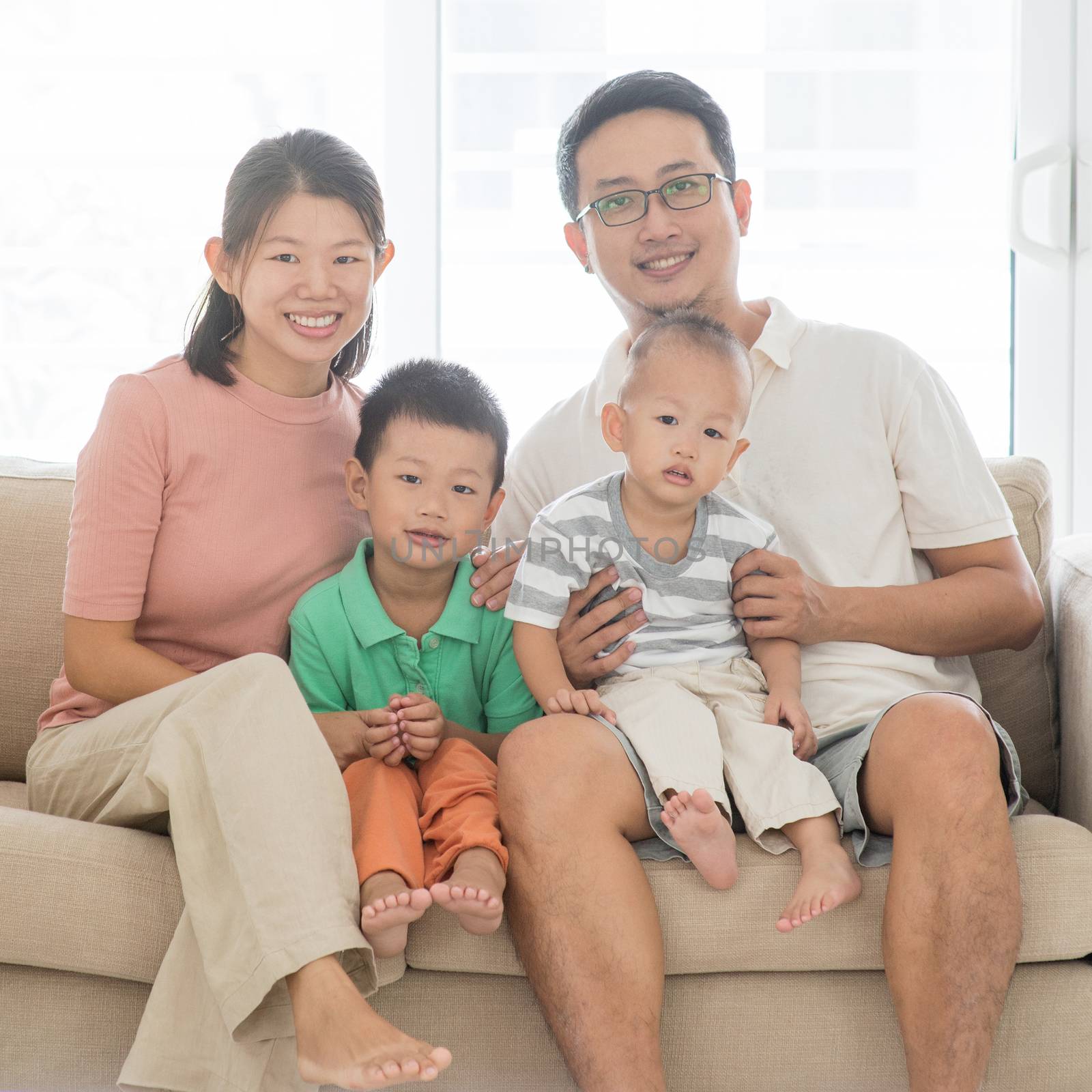 Happy Asian family portrait at home, parents and children indoor lifestyle.