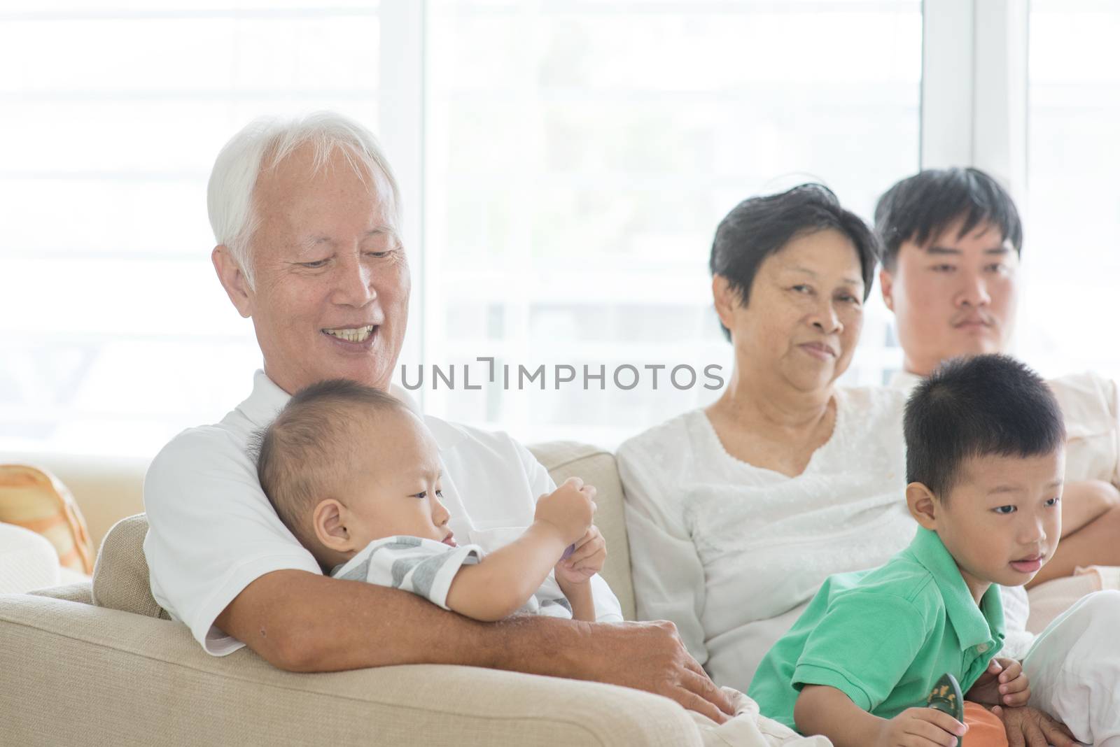 Asian family relaxed at home by szefei