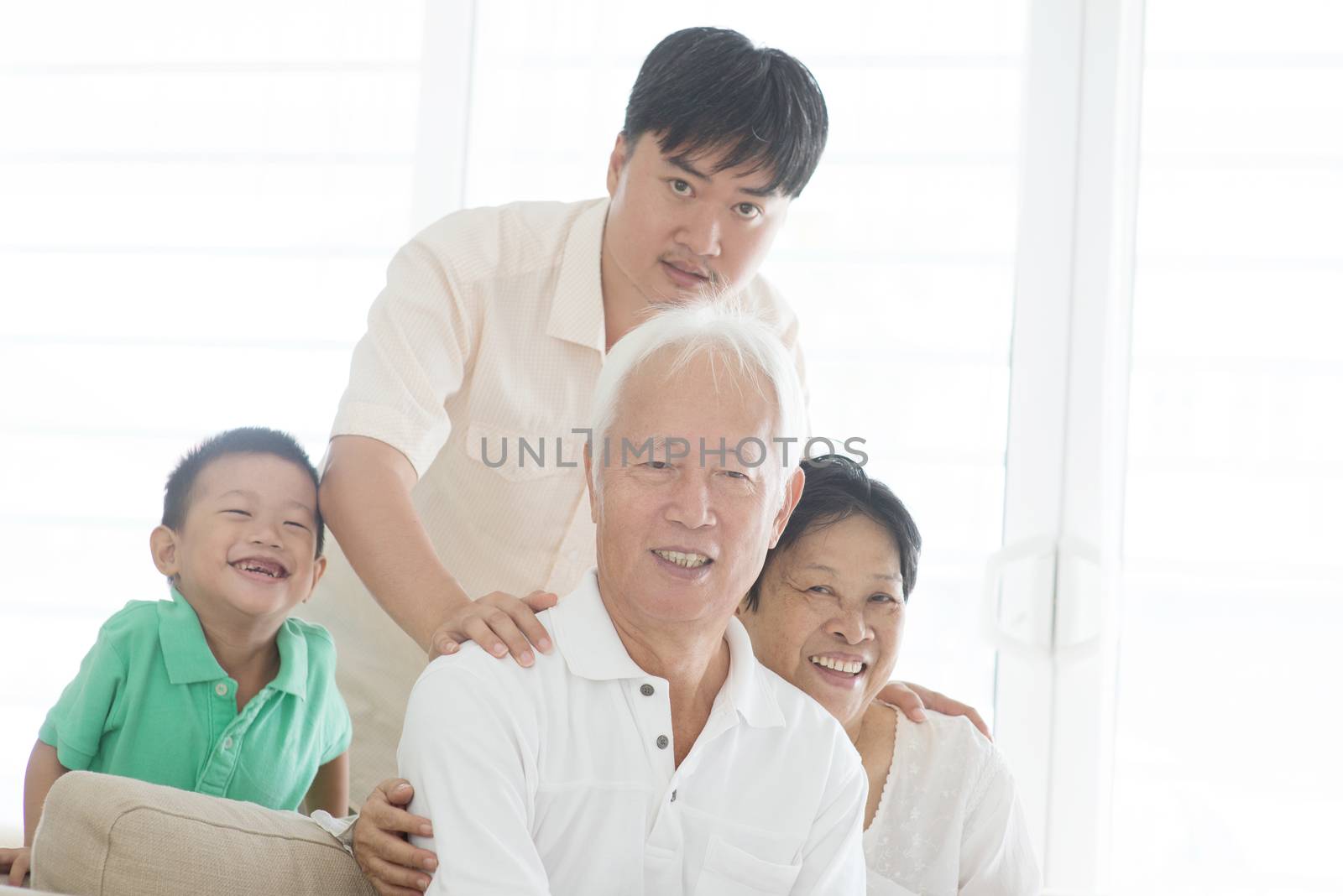 Portrait of happy Asian family at home, multi generations people indoor lifestyle.