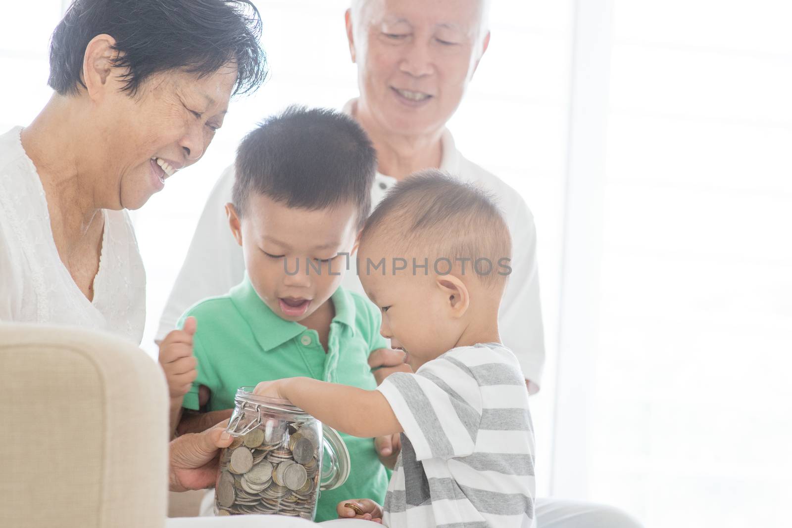 Asian family saving money at home. Financial planning, investment, insurance, retirement, senior and junior banking concept. 
