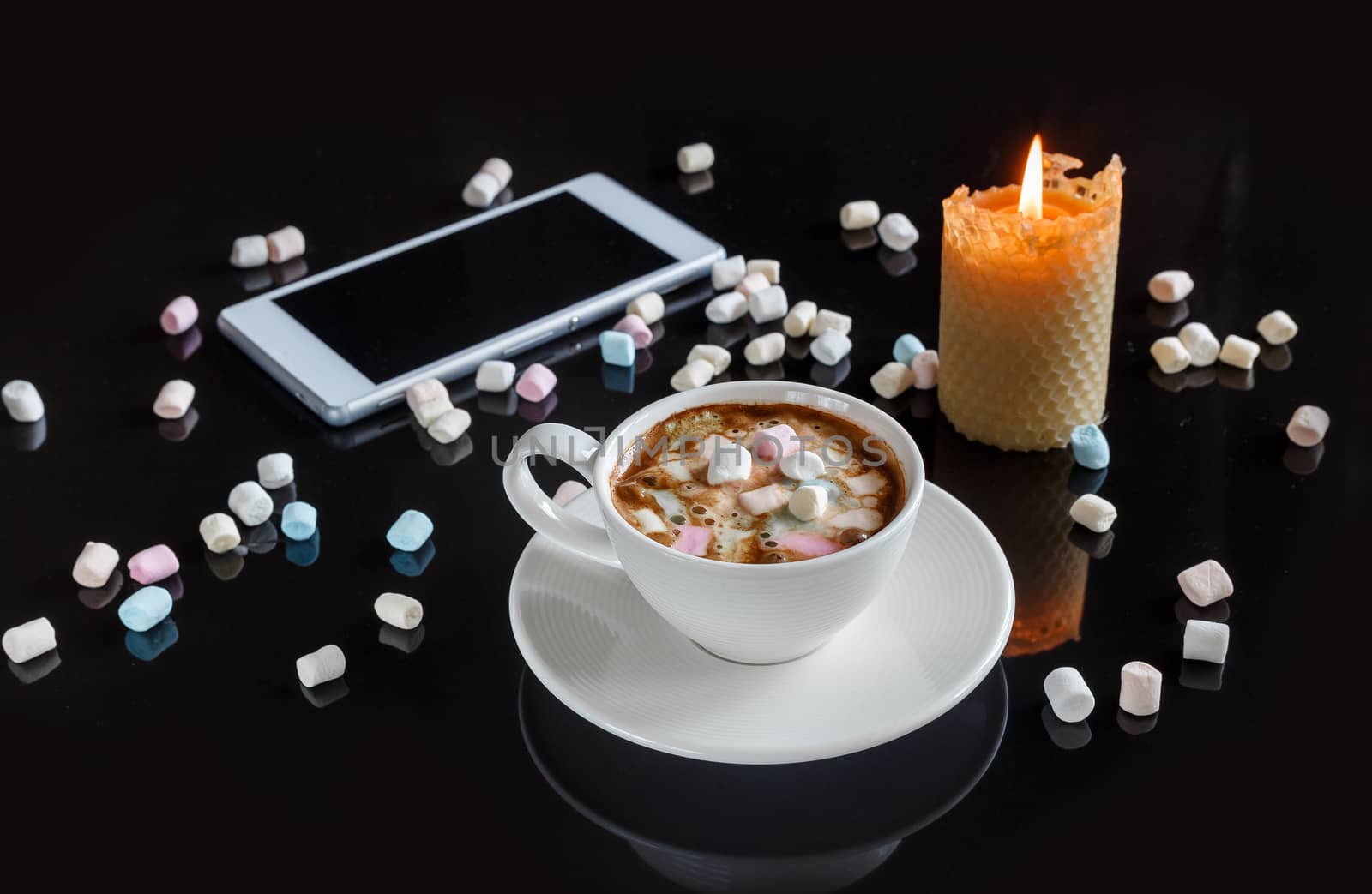 marshmallow in a white cup on a dark background