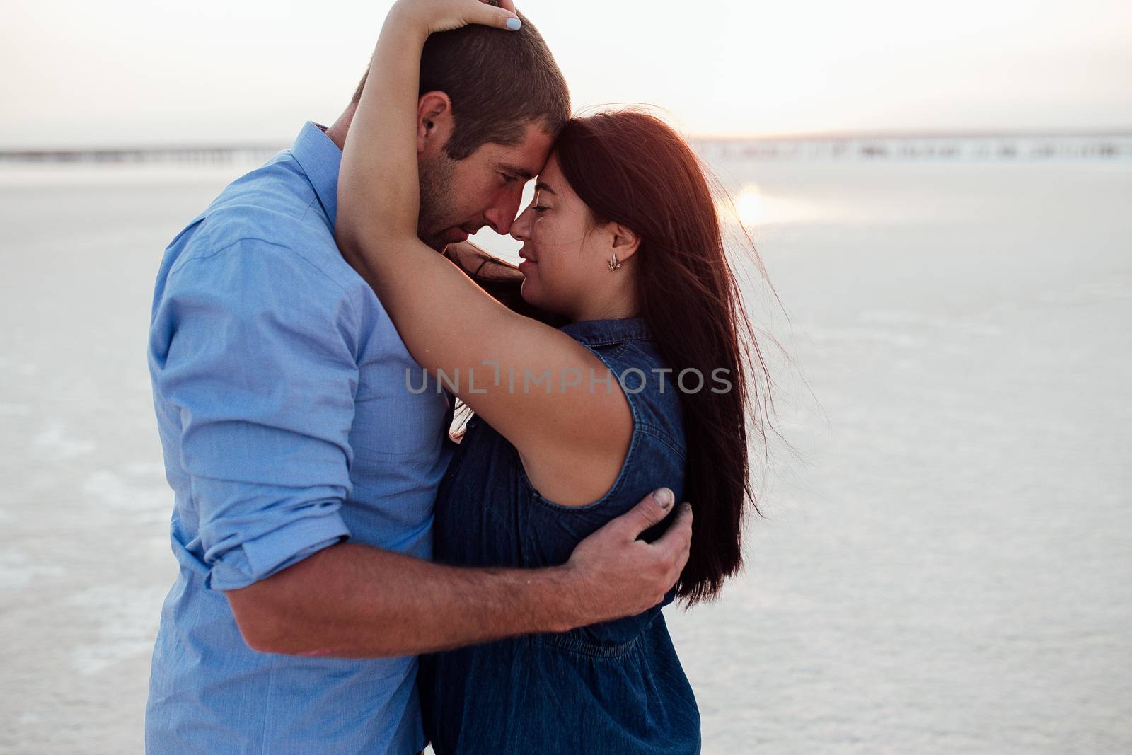 Young happy family walking along the seashore. Pregnant. Long hair. by volkway