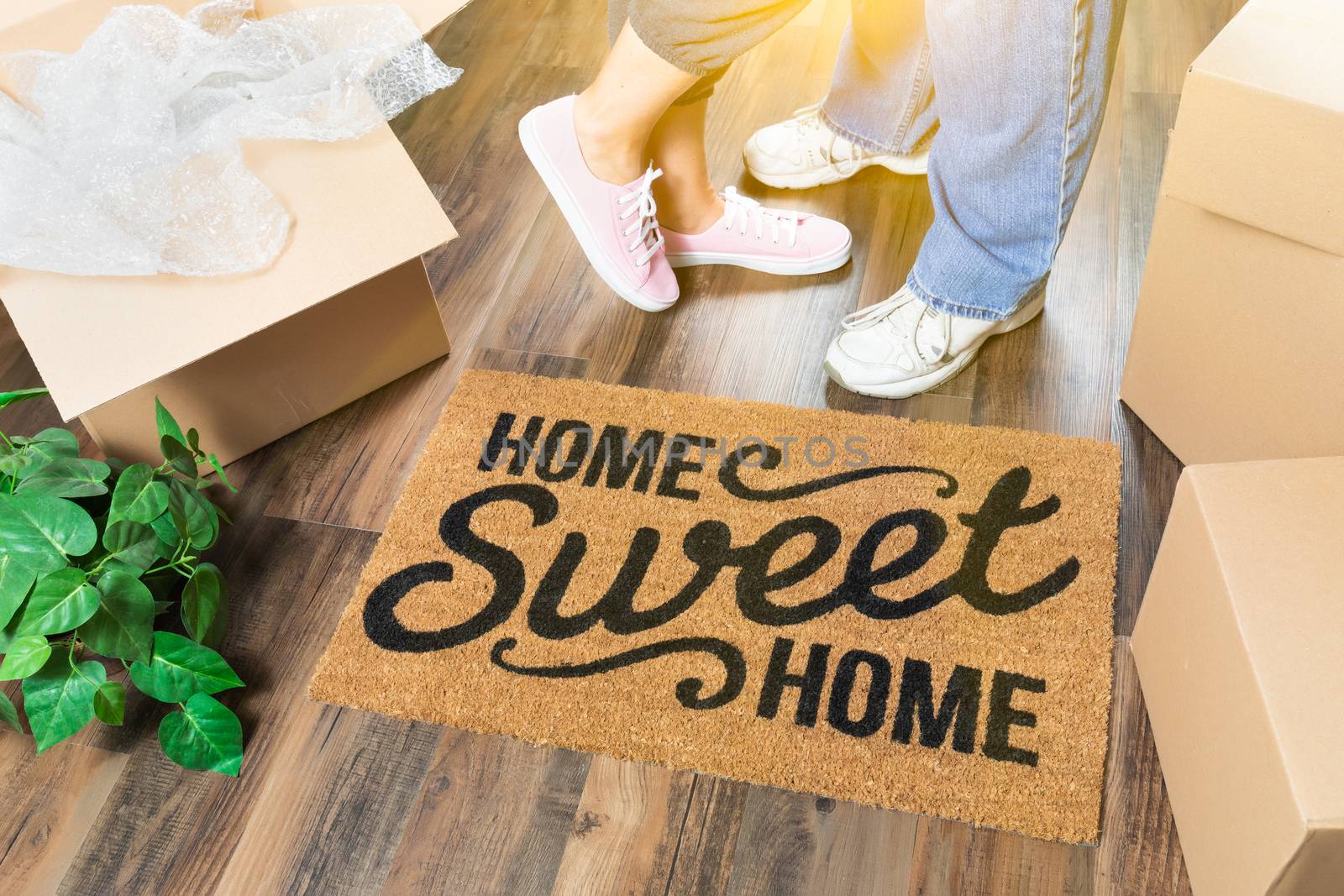 Man and Woman Standing Near Home Sweet Home Welcome Mat, Moving  by Feverpitched