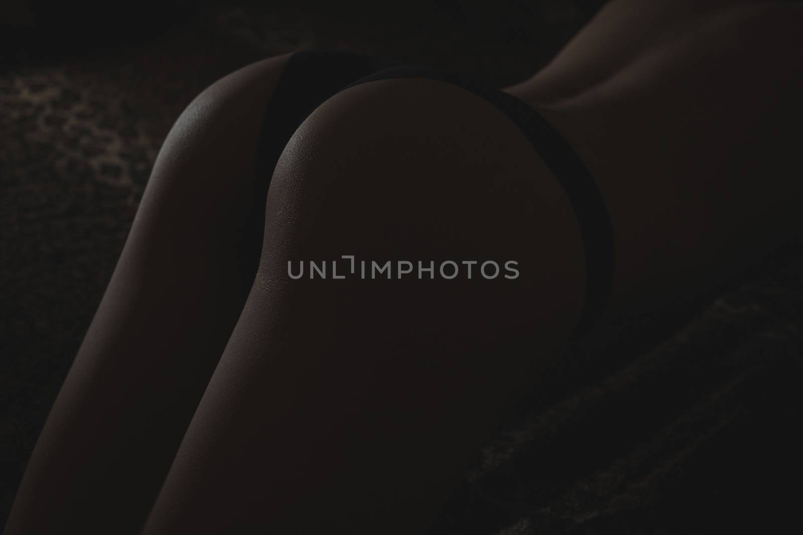 Back and butt naked women.on a black background.