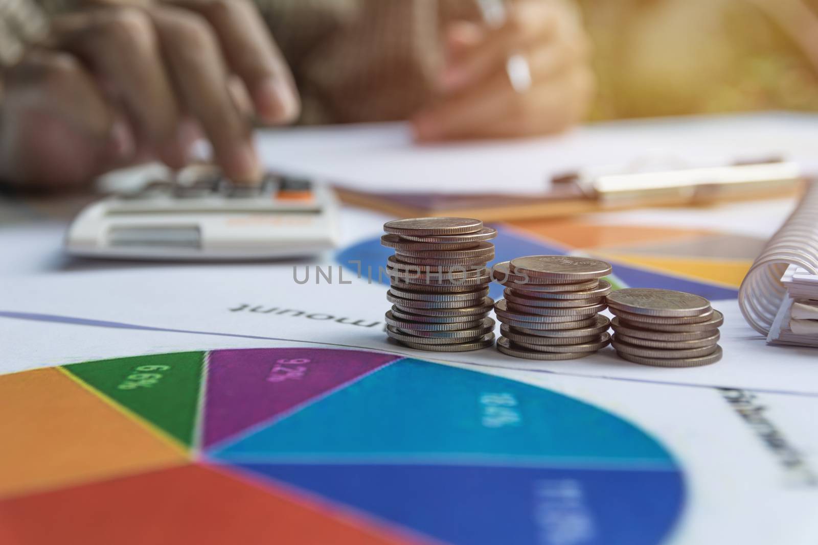 Man using calculator with stock financial indices with stack coin. Financial stock market in accounting market economy analysis.