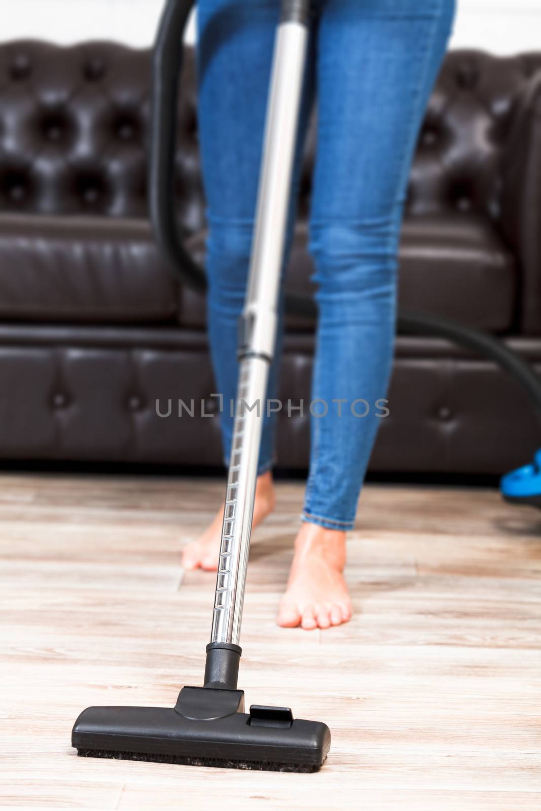 Housewife with a vacuum cleaner, closeup shot