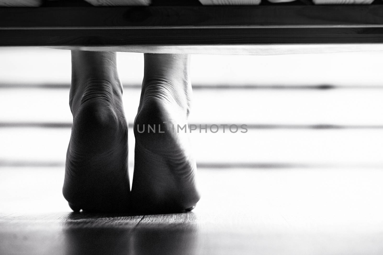 Closeup shot of dangling female bare feet by Nobilior