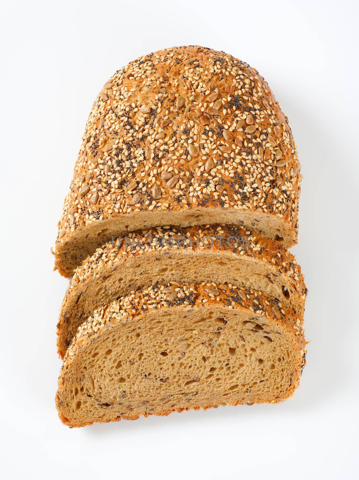 sliced bread with poppy, sunflower and sesame seeds on white background