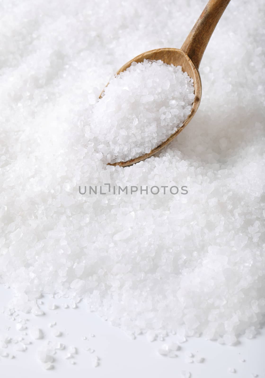 coarse grained sea salt on a wooden spoon