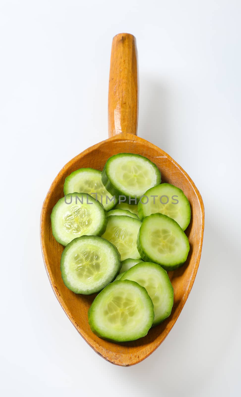 scoop of sliced cucumber on white background