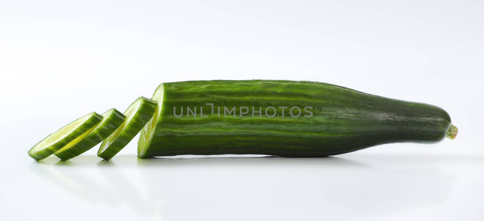 sliced green cucumber on white background - close up