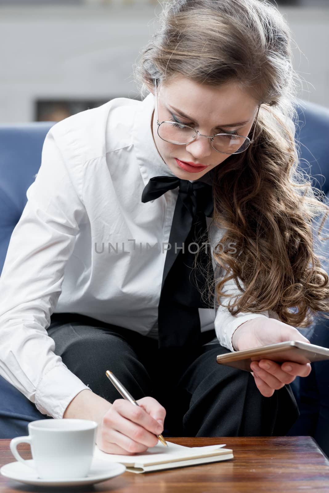 a successful and beautiful businesswoman writes information to a by kosmsos111
