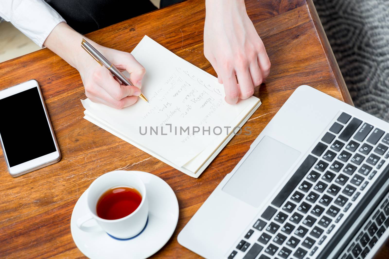 view of the hands at work, writing important information to the by kosmsos111