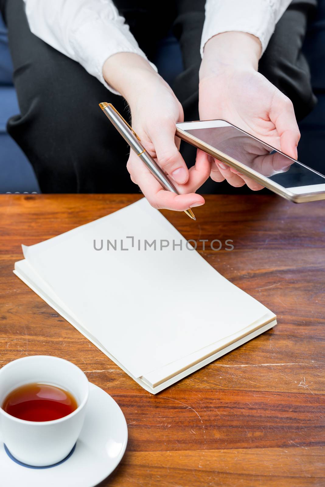 notebook on the table and a businesswoman sitting next by kosmsos111