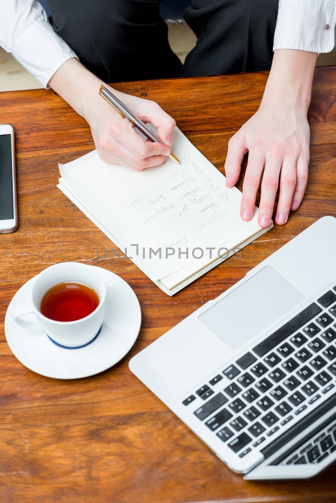 view of the top of the hand at work, writing important informati by kosmsos111