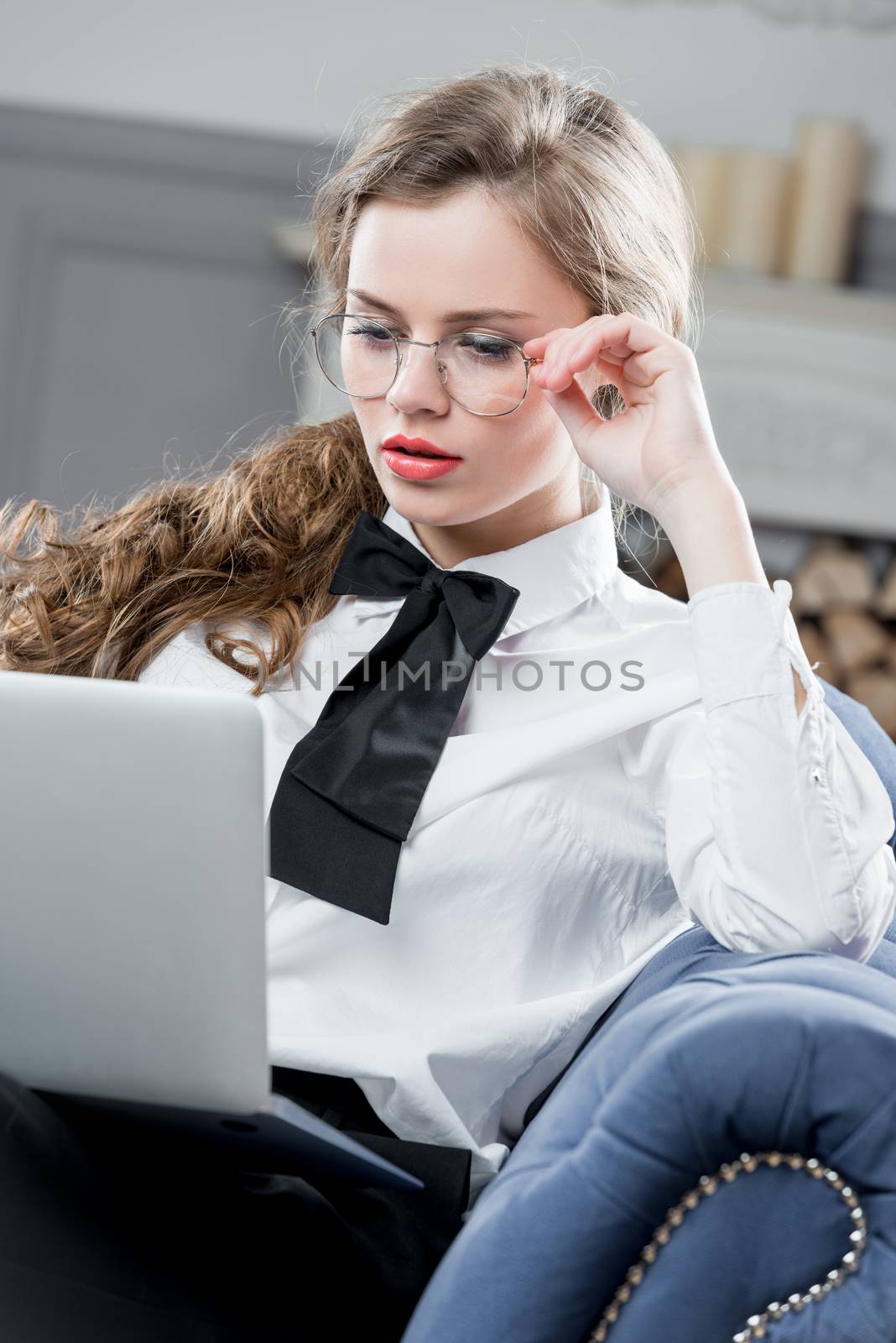 Successful office worker working in laptop sitting on couch by kosmsos111