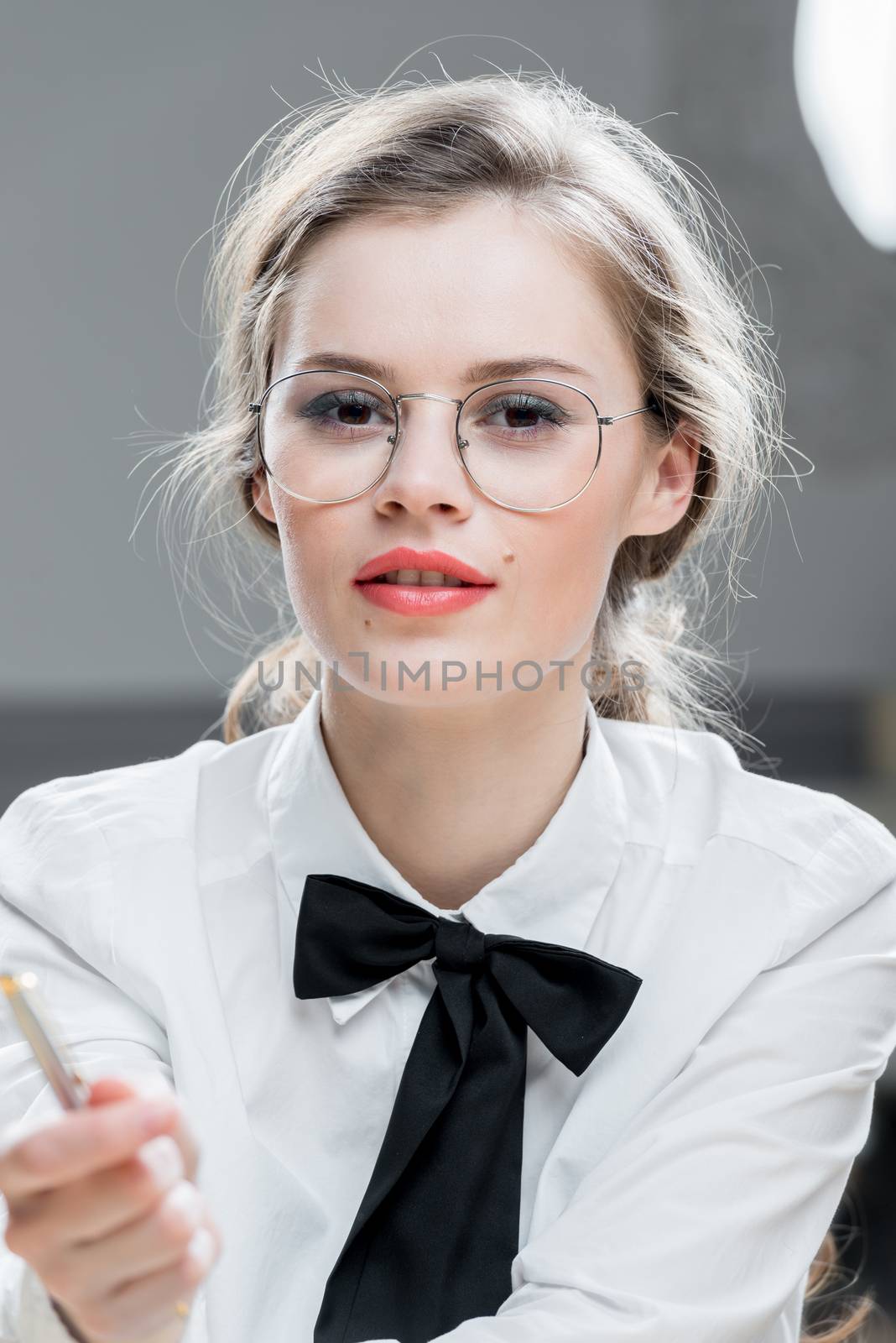 beautiful young and successful businesswoman with glasses, close-up portrait