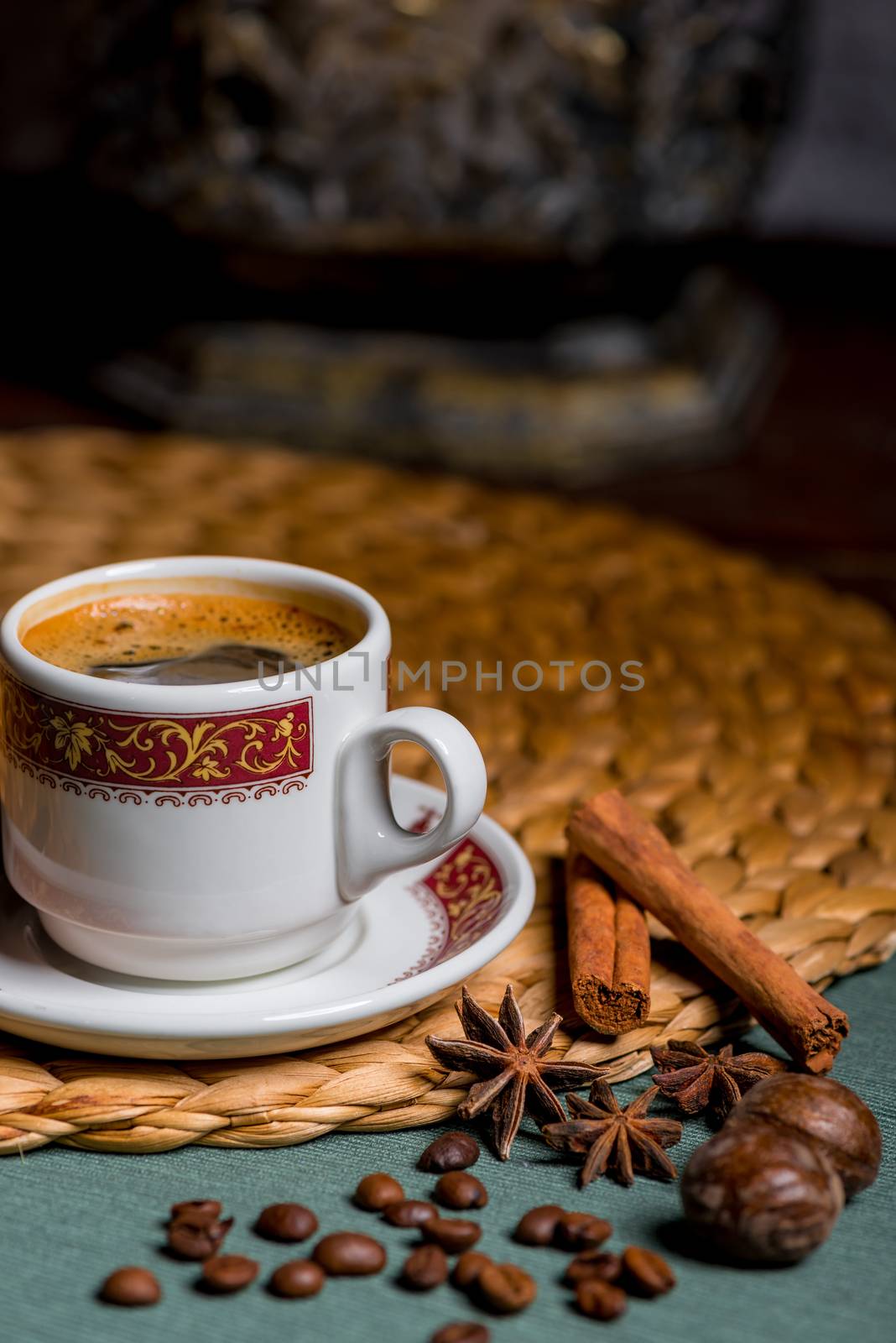 vertical picture of a beautiful cup of coffee, anise and cinnamon still life on a table